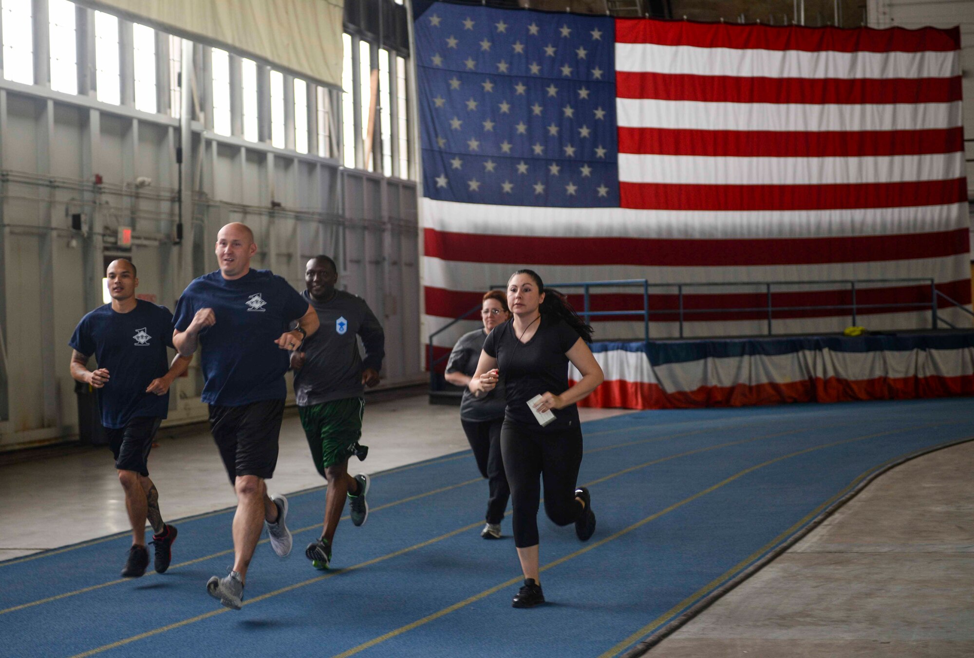 Members of team four run a lap during the Battle of the Chevrons team building exercise at Ellsworth Air Force Base, S.D., May 25, 2016. The goal of the obstacles were to further improve communication and build on relationships already established between first sergeants and chiefs. (U.S. Air Force photo by Airman 1st Class Sadie Colbert/Released)