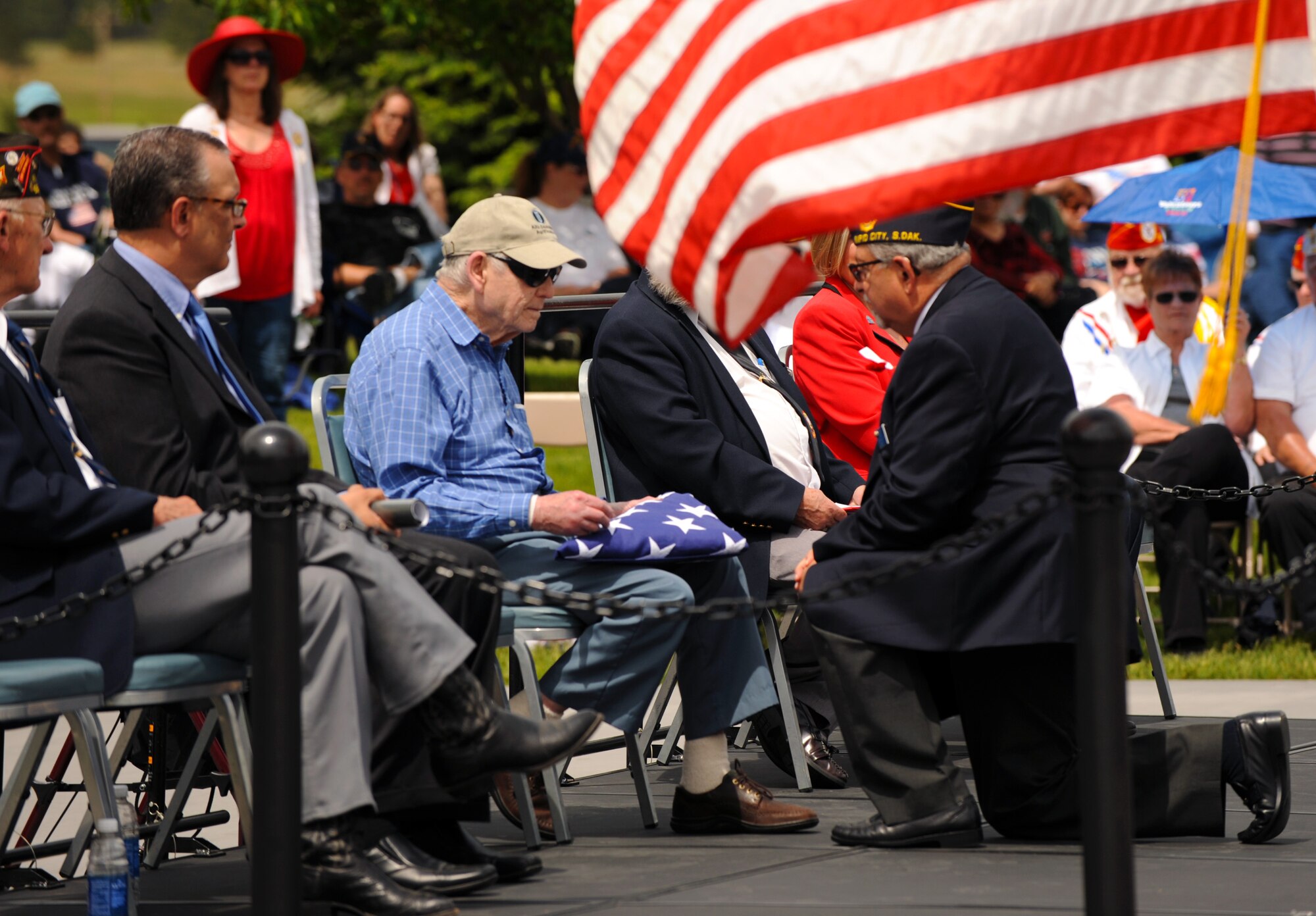 Maurice Crow, a World War II veteran, receives a folded flag during a Memorial Day ceremony at the Black Hills National Cemetery in Sturgis, S.D., May 30, 2016. Crow served in the U.S. Army Air Corps from 1942 to 1945 as an in-flight mechanic for the B-17 Flying Fortress. (U.S. Air Force photo by Airman 1st Class Denise M. Nevins/Released)