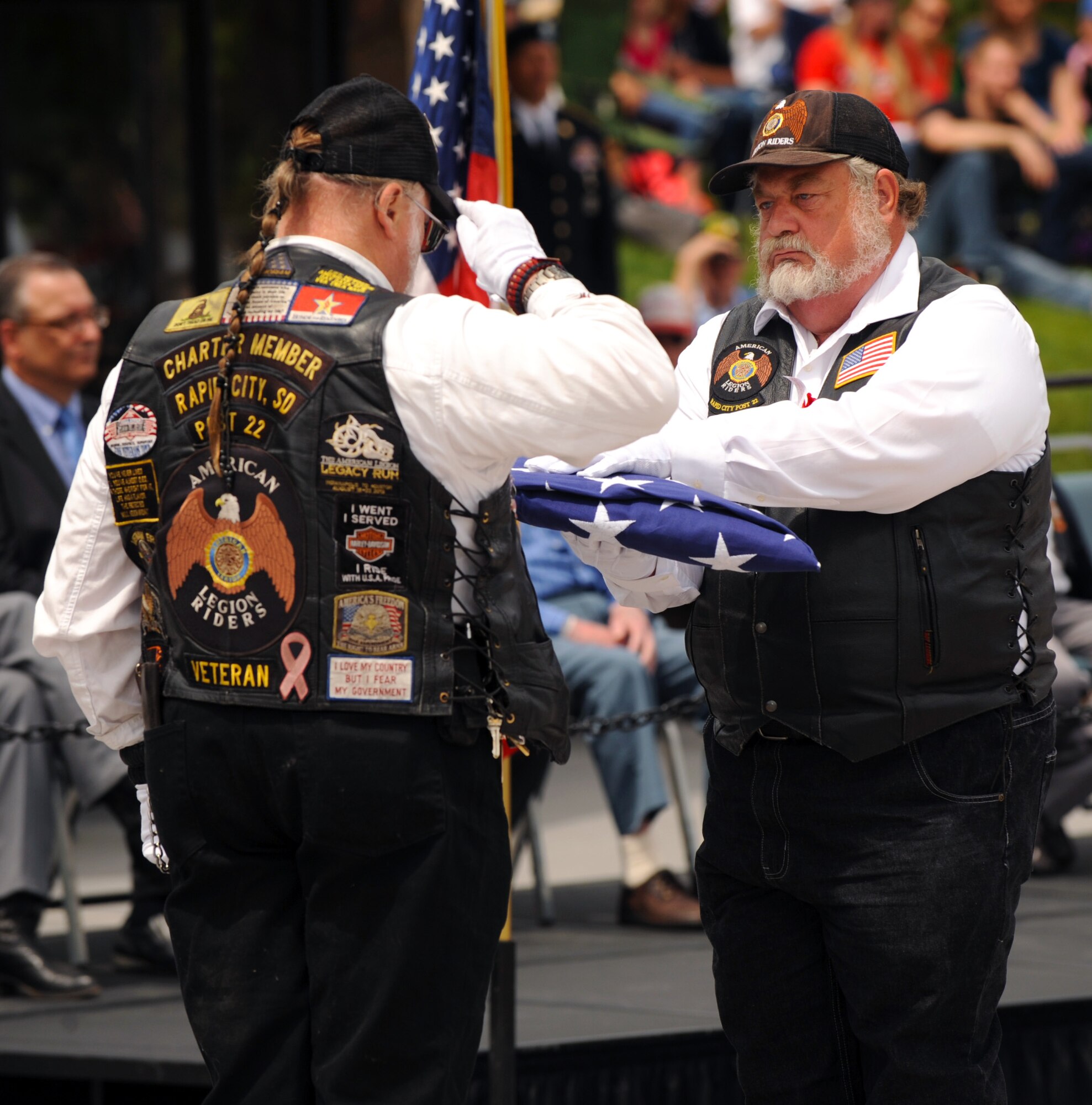 Members of the American Legion Riders Post #22 perform a passing of the flag during a Memorial Day ceremony at the Black Hills National Cemetery in Sturgis, S.D., May 30, 2016. For more than 200 years the American flag has been a symbol of freedom, inspiring Americans both at home and abroad. (U.S. Air Force photo by Airman 1st Class Denise M. Nevins/Released)