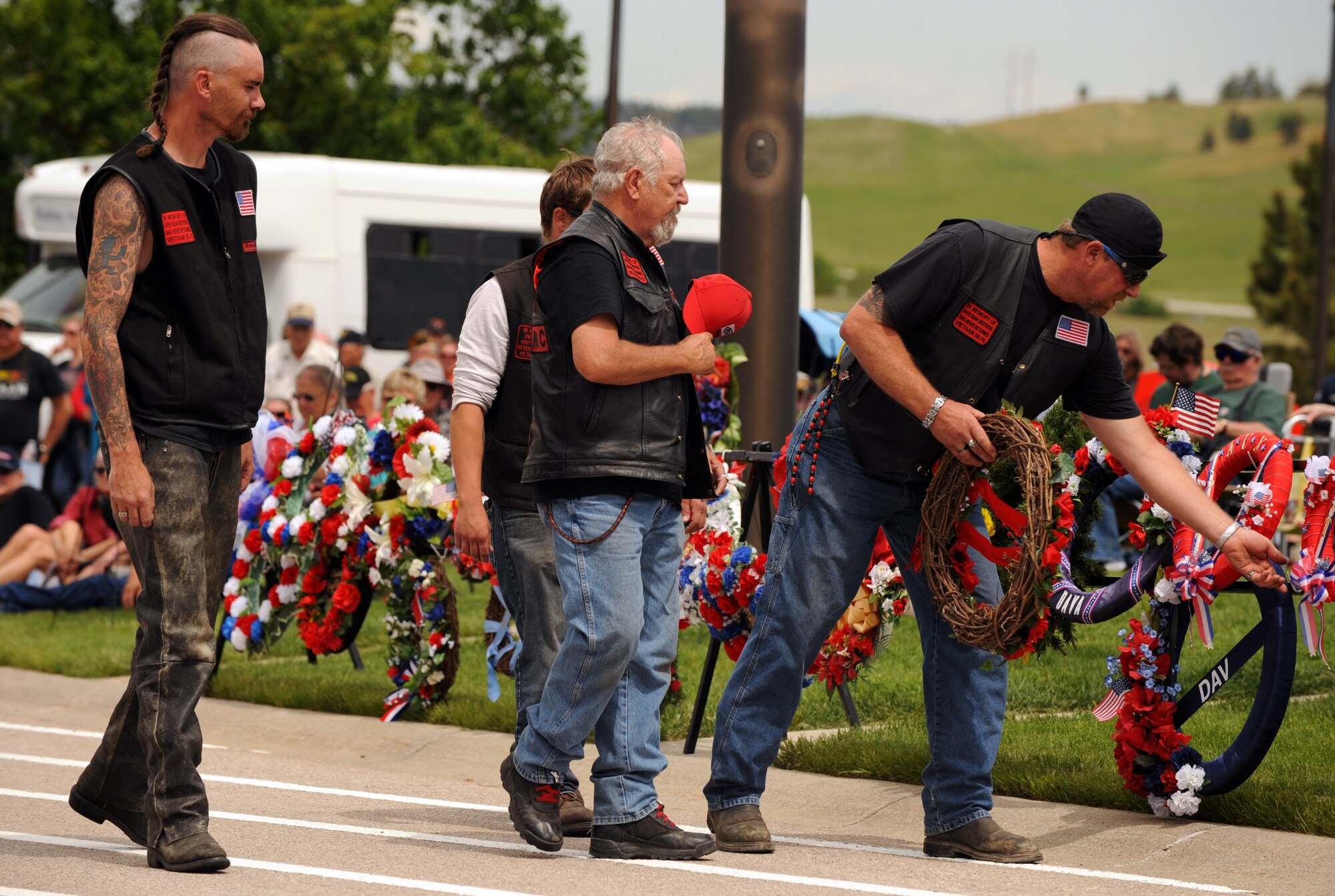 Members of the Second Brigade Motorcycle Club lay down a wreath during the Memorial Day ceremony at the Black Hills National Cemetery in Sturgis, S.D., May 30, 2016. The laying of wreaths was a symbolic tribute to the men and women who died while serving on active duty. (U.S. Air Force photo by Airman 1st Class Denise M. Nevins/Released)