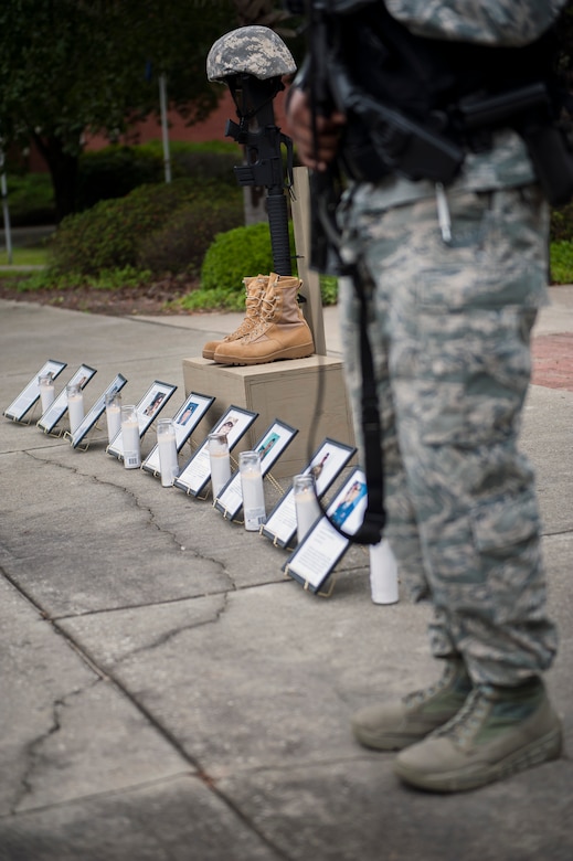 A 628th Security Forces Airman guards a memorial honoring fallen service members during Police Week at Joint Base Charleston, S.C. May 18, 2016. A 24-hour silent vigil was held for nine law enforcement Airmen who made the ultimate sacrifice. (U.S. Air Force photo/Staff Sgt. Jared Trimarchi) 