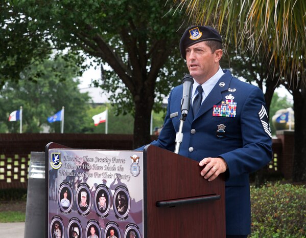 Chief Master Sergeant Robert Grimsley delivers comments as the guest speaker during the National Police Week ceremony May 20, 2016, at the base flag pole on Joint Base Charleston – Air Base, S.C.  In honor of Police Week, the 628th SFS collaborated with multiple base agencies to conduct various events to remember and celebrate their fallen brothers and sisters in law enforcement. (U.S. Air Force Photo/Airman 1st Class Haleigh Laverty)