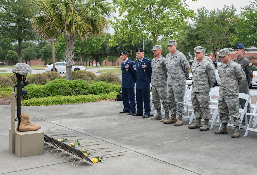 Joint Base Charleston leadership stand for a moment of silence to honor the fallen defenders during the National Police Week ceremony May 20, 2016, at the base flag pole on Joint Base Charleston – Air Base, S.C.  In honor of Police Week, the 628th SFS collaborated with multiple base agencies to conduct various events to remember and celebrate their fallen brothers and sisters in law enforcement. (U.S. Air Force Photo/Airman 1st Class Haleigh Laverty)