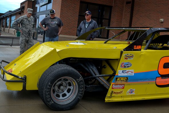 Eric Folstad, driver of the 96F racecar, talks with Master Sgt. Cory Vrieze, fuels information service center section chief assigned to the 5th Logistics Readiness Squadron, at the Base Exchange at Minot Air Force Base, N.D., May 25, 2016. Drivers were displaying cars, did some giveaways and informed Team Minot of the speedway events this summer and on May 30 for Military Appreciation Day. (U.S. Air Force photo/Airman 1st Class Jessica Weissman)