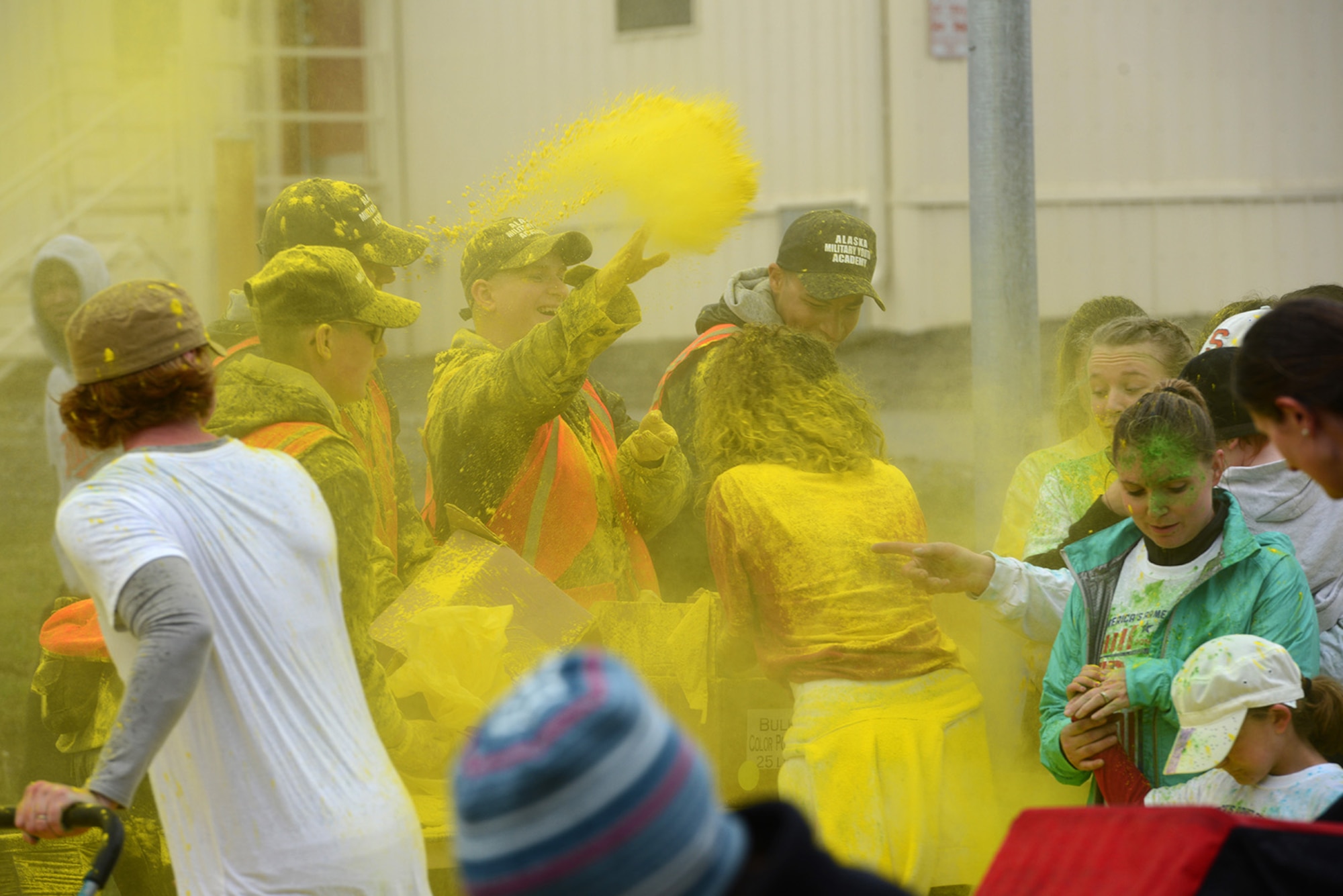 Alaska Military Youth Academy volunteers throw yellow-dyed cornstarch at participants during the America’s Armed Forces Color Run at Joint Base Elmendorf-Richardson, Alaska, May 21, 2016. The Alaska Military Youth Academy, JBER Life, USO, and volunteers provided water, food, photo opportunities, and dye at multiple stations along the run. (U.S. Air Force photo by Airman 1st Class Christopher R. Morales)