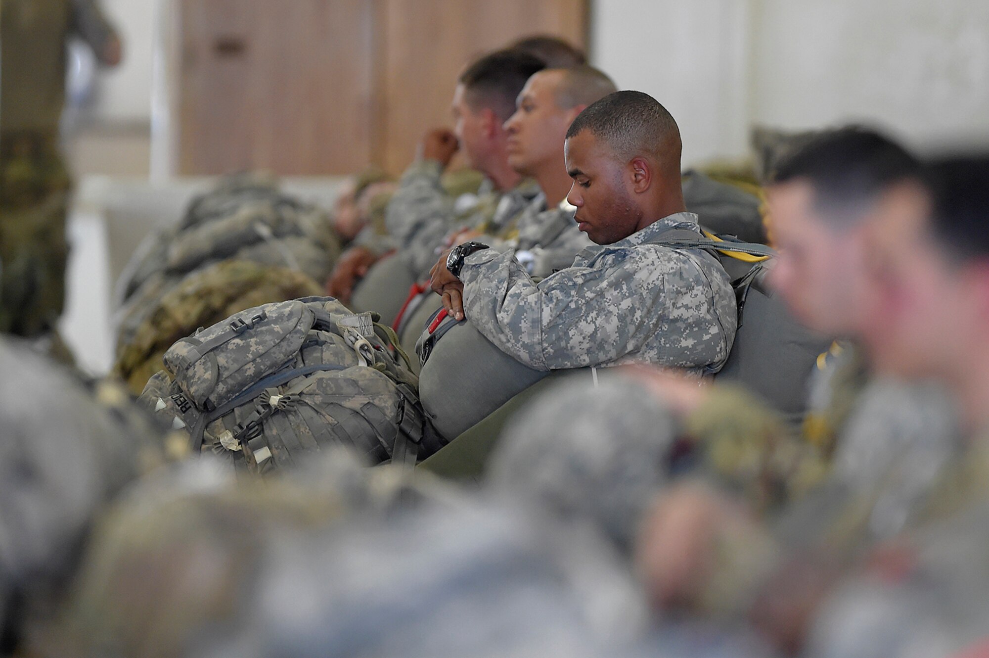 A U.S. Army paratrooper assigned to the 1st Battalion, 501st Parachute Infantry Regiment, 4th Infantry Brigade Combat Team (Airborne), 25th Infantry Division, waits to board a C-17 Globemaster III before conducting joint airborne and air transportability training (JAATT) at Joint Base Elmendorf-Richardson, Alaska, May 19, 2016. JAATT familiarizes units with establishing drop zones and airfields, as well as proper communication with aircraft supporting resupply missions. The Soldiers of 4/25 IBCT belong to the only American airborne brigade in the Pacific and are trained to execute airborne maneuvers in extreme cold weather/high altitude environments in support of combat, partnership and disaster relief operations. (U.S. Air Force photo by Alejandro Pena)