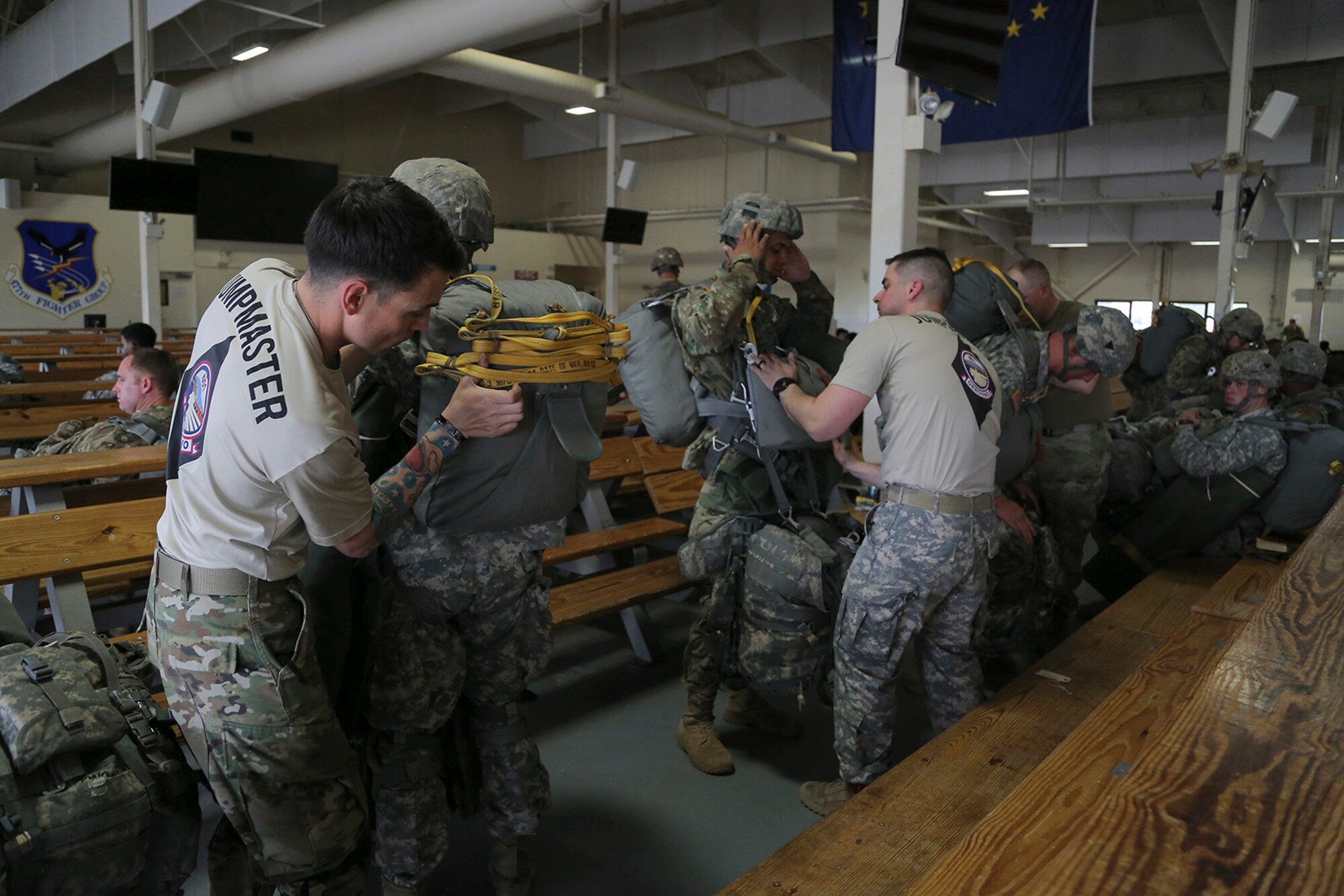 U.S. Army jumpmasters assigned to the 1st Battalion, 501st Parachute Infantry Regiment, 4th Infantry Brigade Combat Team (Airborne), 25th Infantry Division, ensure that their fellow paratroopers are properly outfitted before conducting joint airborne and air transportability training (JAATT) at Joint Base Elmendorf-Richardson, Alaska, May 19, 2016. JAATT familiarizes units with establishing drop zones and airfields, as well as proper communication with aircraft supporting resupply missions. The Soldiers of 4/25 IBCT belong to the only American airborne brigade in the Pacific and are trained to execute airborne maneuvers in extreme cold weather/high altitude environments in support of combat, partnership and disaster relief operations. (U.S. Air Force photo by Alejandro Pena)