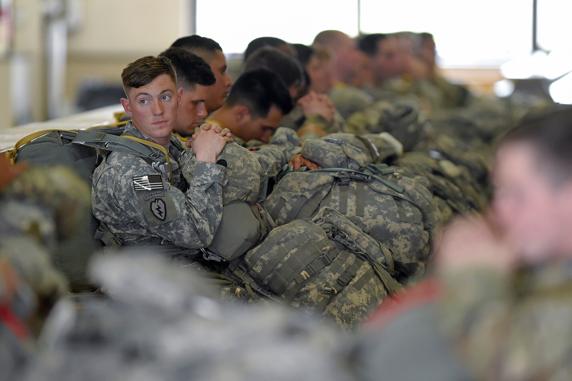U.S. Army paratroopers assigned to the 1st Battalion, 501st Parachute Infantry Regiment, 4th Infantry Brigade Combat Team (Airborne), 25th Infantry Division, wait to board aircraft before conducting joint airborne and air transportability training (JAATT) at Joint Base Elmendorf-Richardson, Alaska, May 19, 2016. JAATT familiarizes units with establishing drop zones and airfields, as well as proper communication with aircraft supporting resupply missions. The Soldiers of 4/25 IBCT belong to the only American airborne brigade in the Pacific and are trained to execute airborne maneuvers in extreme cold weather/high altitude environments in support of combat, partnership and disaster relief operations. (U.S. Air Force photo by Alejandro Pena)