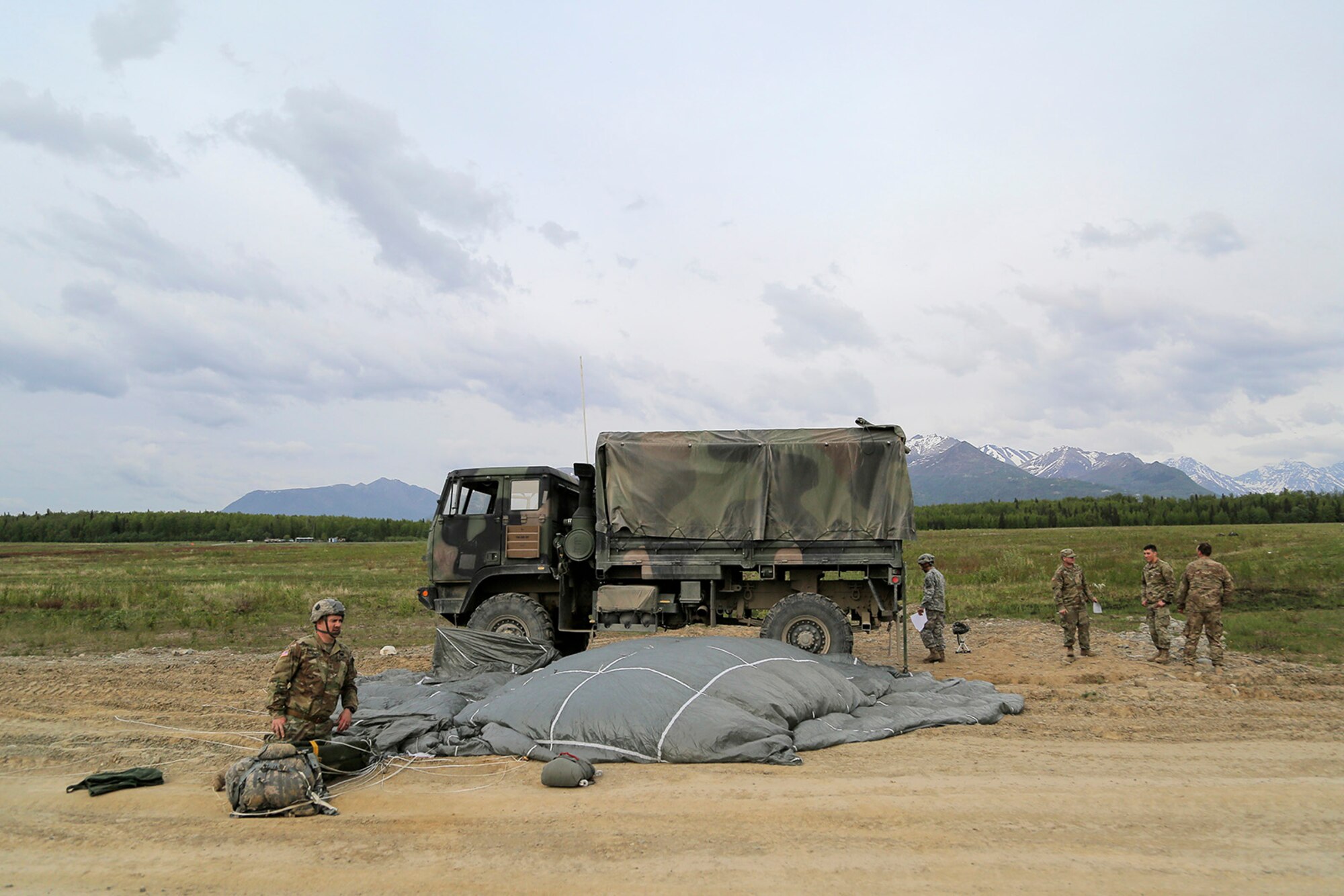 U.S. Army paratroopers assigned to the 1st Battalion, 501st Parachute Infantry Regiment, 4th Infantry Brigade Combat Team (Airborne), 25th Infantry Division, conduct joint airborne and air transportability training (JAATT) at Joint Base Elmendorf-Richardson, Alaska, May 19, 2016. JAATT familiarizes units with establishing drop zones and airfields, as well as proper communication with aircraft supporting resupply missions. The Soldiers of 4/25 IBCT belong to the only American airborne brigade in the Pacific and are trained to execute airborne maneuvers in extreme cold weather/high altitude environments in support of combat, partnership and disaster relief operations. (U.S. Air Force photo by Alejandro Peña)