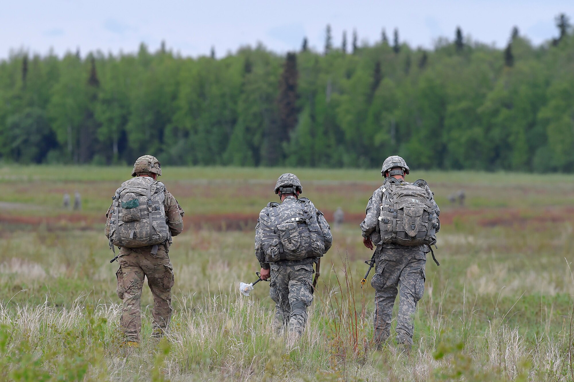 U.S. Army paratroopers assigned to the 1st Battalion, 501st Parachute Infantry Regiment, 4th Infantry Brigade Combat Team (Airborne), 25th Infantry Division, proceed to the rally point after completing joint airborne and air transportability training (JAATT) at Joint Base Elmendorf-Richardson, Alaska, May 19, 2016. JAATT familiarizes units with establishing drop zones and airfields, as well as proper communication with aircraft supporting resupply missions. The Soldiers of 4/25 IBCT belong to the only American airborne brigade in the Pacific and are trained to execute airborne maneuvers in extreme cold weather/high altitude environments in support of combat, partnership and disaster relief operations. (U.S. Air Force photo by Alejandro Pena)