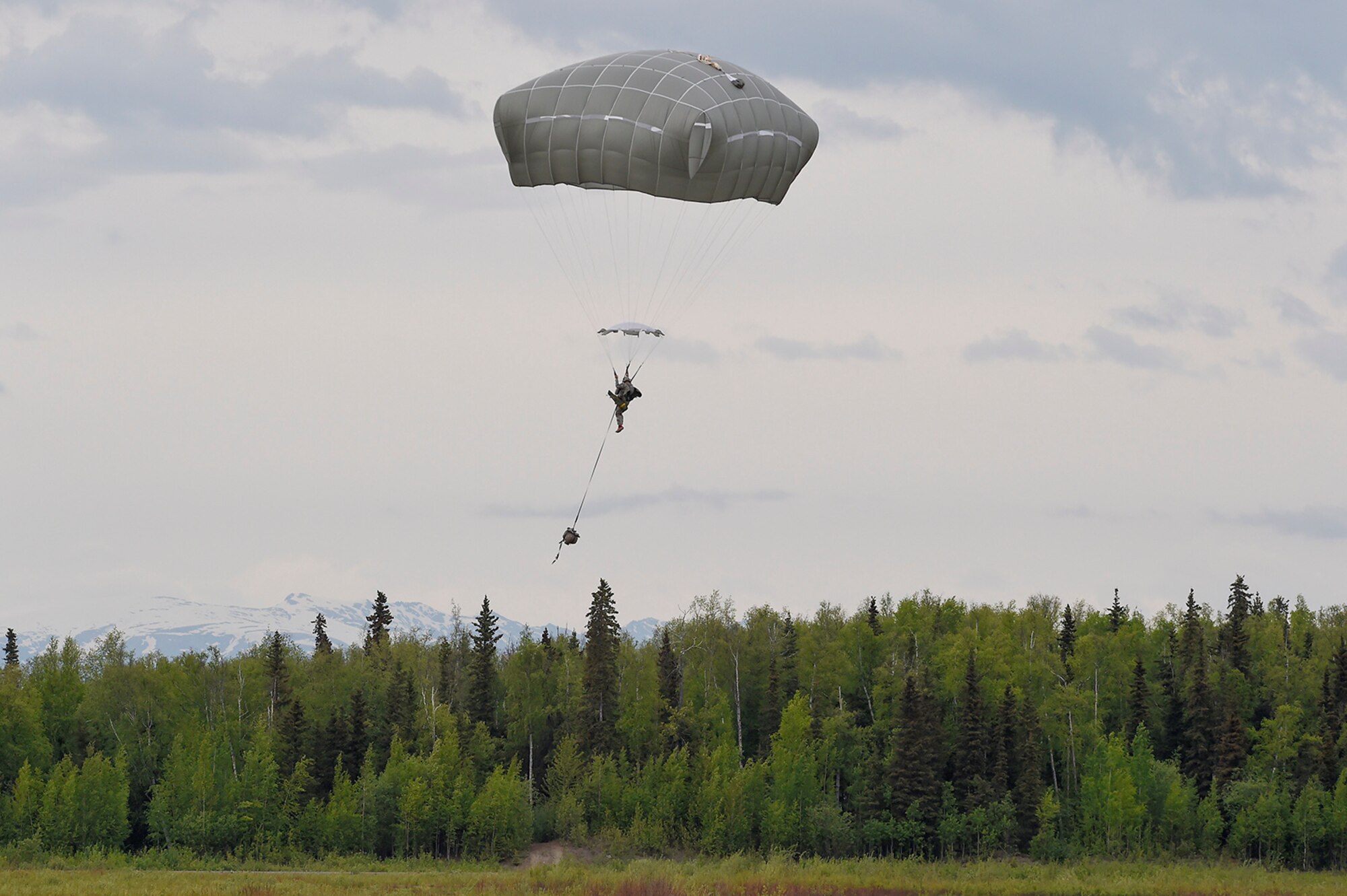 U.S. Army paratroopers assigned to the 1st Battalion, 501st Parachute Infantry Regiment, 4th Infantry Brigade Combat Team (Airborne), 25th Infantry Division, conduct joint airborne and air transportability training (JAATT) at Joint Base Elmendorf-Richardson, Alaska, May 19, 2016. JAATT familiarizes units with establishing drop zones and airfields, as well as proper communication with aircraft supporting resupply missions. The Soldiers of 4/25 IBCT belong to the only American airborne brigade in the Pacific and are trained to execute airborne maneuvers in extreme cold weather/high altitude environments in support of combat, partnership and disaster relief operations. (U.S. Air Force photo by Alejandro Peña)