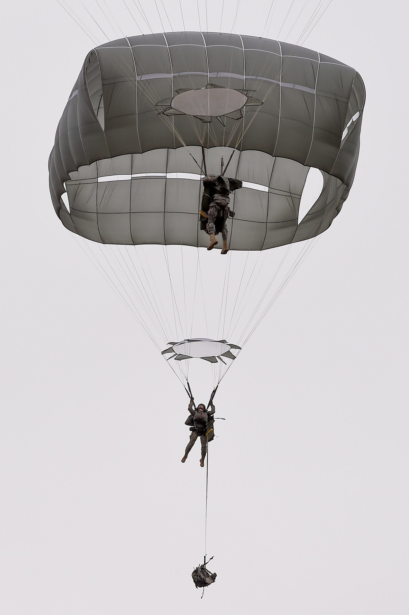 U.S. Army paratroopers assigned to the 1st Battalion, 501st Parachute Infantry Regiment, 4th Infantry Brigade Combat Team (Airborne), 25th Infantry Division, descend over Malemute drop zone during joint airborne and air transportability training (JAATT) at Joint Base Elmendorf-Richardson, Alaska, May 19, 2016. JAATT familiarizes units with establishing drop zones and airfields, as well as proper communication with aircraft supporting resupply missions. The Soldiers of 4/25 IBCT belong to the only American airborne brigade in the Pacific and are trained to execute airborne maneuvers in extreme cold weather/high altitude environments in support of combat, partnership and disaster relief operations. (U.S. Air Force photo by Alejandro Pena)