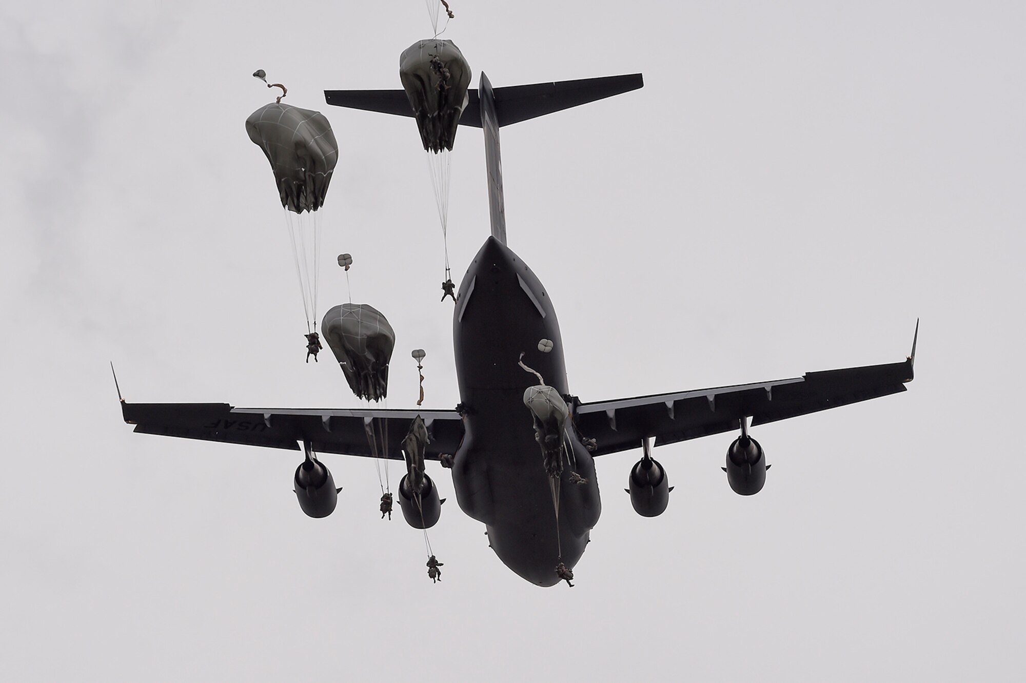 U.S. Army paratroopers assigned to the 1st Battalion, 501st Parachute Infantry Regiment, 4th Infantry Brigade Combat Team (Airborne), 25th Infantry Division, jump from a U.S. Air Force C-17 Globemaster III, assigned to the 517th Airlift Squadron, during joint airborne and air transportability training (JAATT) at Joint Base Elmendorf-Richardson, Alaska, May 19, 2016. JAATT familiarizes units with establishing drop zones and airfields, as well as proper communication with aircraft supporting resupply missions. The Soldiers of 4/25 IBCT belong to the only American airborne brigade in the Pacific and are trained to execute airborne maneuvers in extreme cold weather/high altitude environments in support of combat, partnership and disaster relief operations. (U.S. Air Force photo by Alejandro Pena)