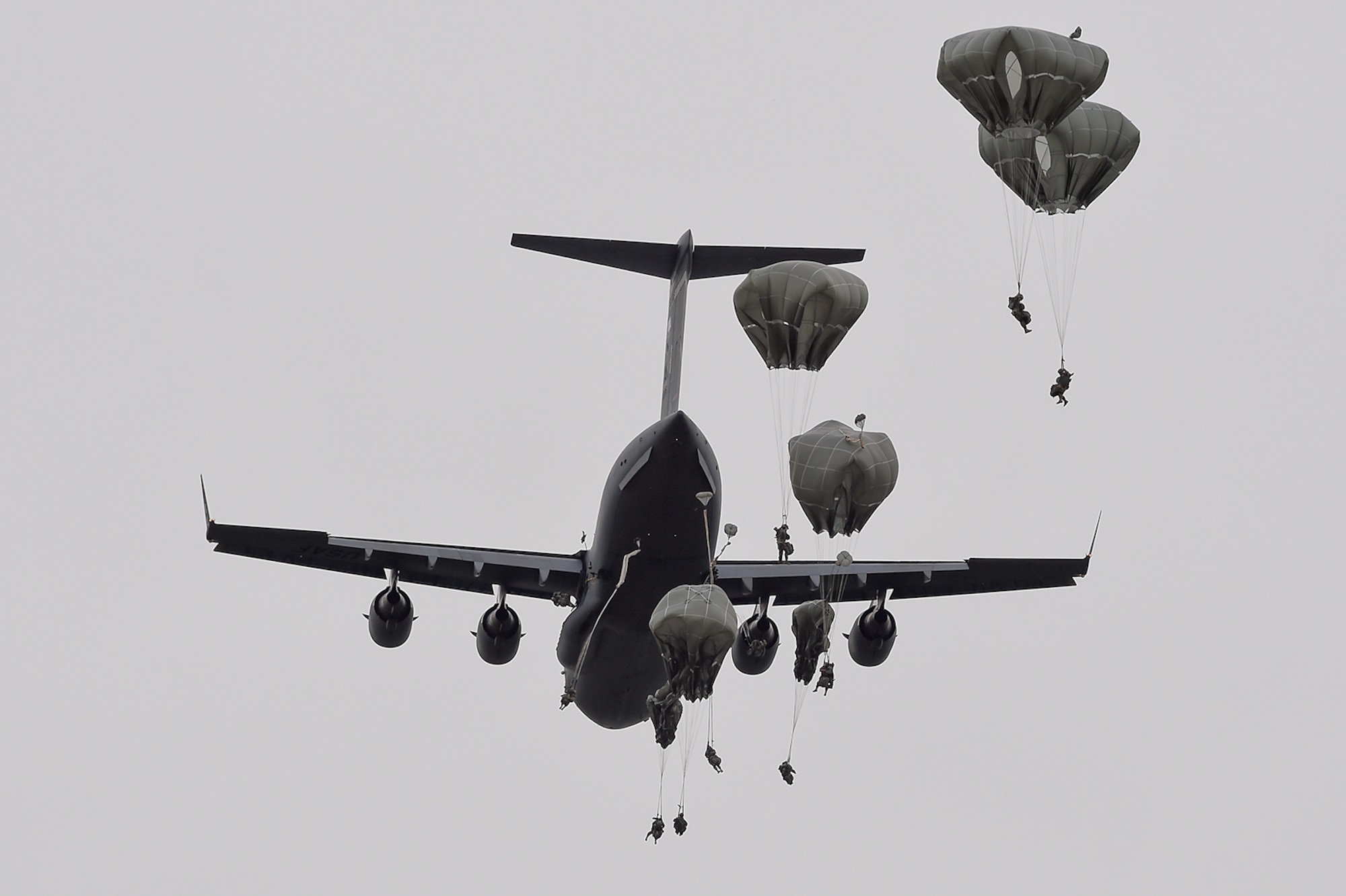 U.S. Army paratroopers assigned to the 1st Battalion, 501st Parachute Infantry Regiment, 4th Infantry Brigade Combat Team (Airborne), 25th Infantry Division, jump from a U.S. Air Force C-17 Globemaster III, assigned to the 517th Airlift Squadron, during joint airborne and air transportability training (JAATT) at Joint Base Elmendorf-Richardson, Alaska, May 19, 2016. JAATT familiarizes units with establishing drop zones and airfields, as well as proper communication with aircraft supporting resupply missions. The Soldiers of 4/25 IBCT belong to the only American airborne brigade in the Pacific and are trained to execute airborne maneuvers in extreme cold weather/high altitude environments in support of combat, partnership and disaster relief operations. (U.S. Air Force photo by Alejandro Pena)