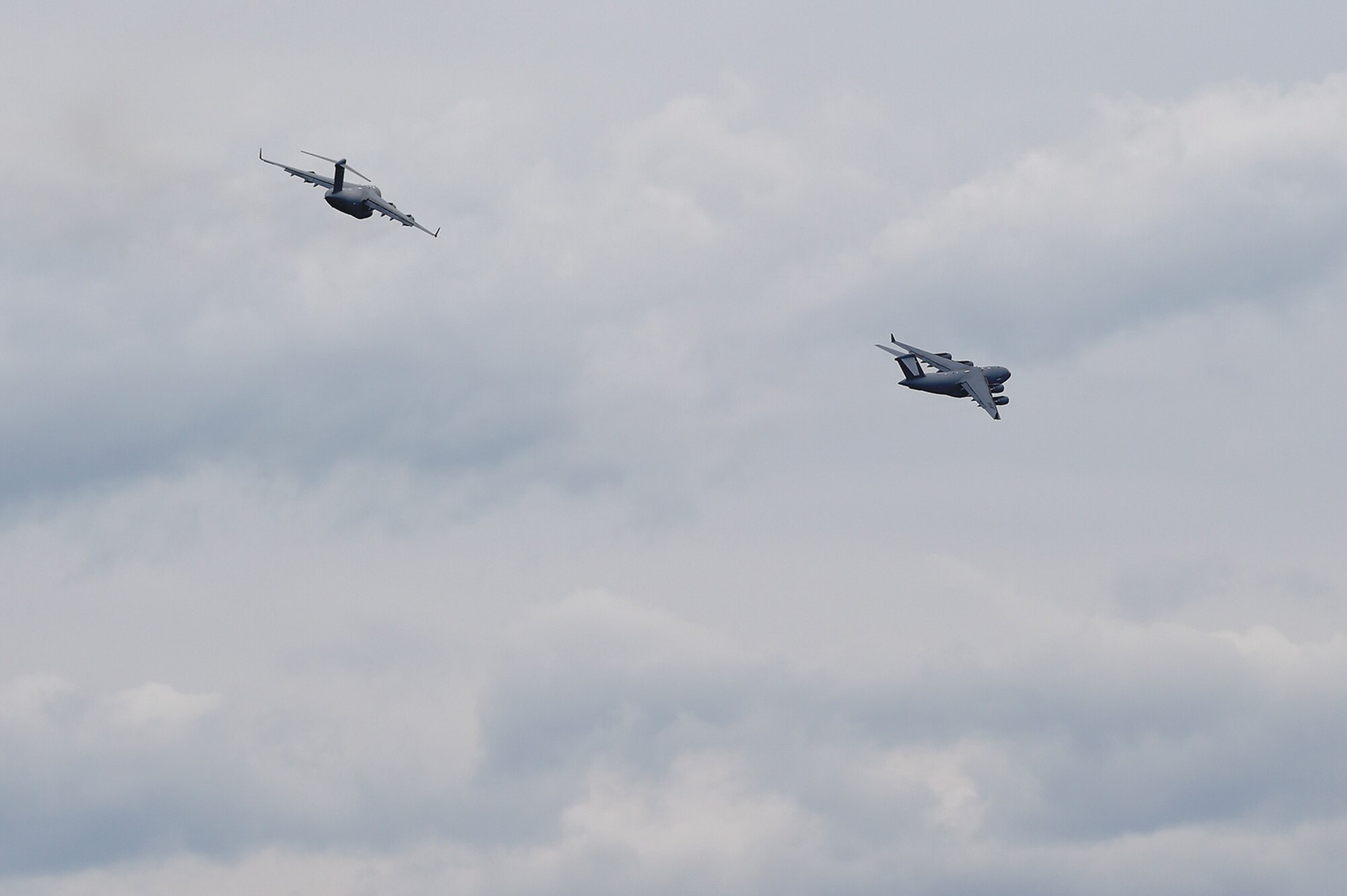 Two U.S. Air Force C-17 Globemaster IIIs, assigned to the 517th Airlift Squadron, participate in joint airborne and air transportability training at Joint Base Elmendorf-Richardson, Alaska, May 19, 2016. JAATT familiarizes units with establishing drop zones and airfields, as well as proper communication with aircraft supporting resupply missions. (U.S. Air Force photo by Alejandro Pena)