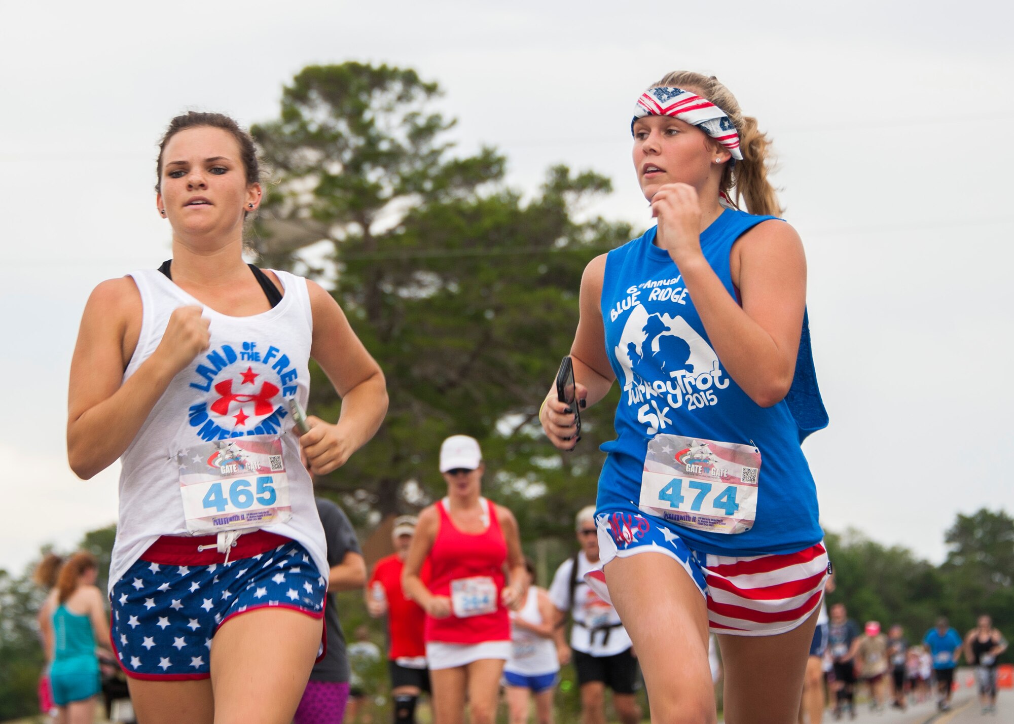Young runners dressed in patriotic colors sprint toward the finish line during the 31st annual Gate-to-Gate Run May 28 at Eglin Air Force Base, Fla. More than 1,050 runners and walkers partook in the Memorial Day Race and paid respects to the country’s fallen with red flowers at the All Wars Memorial as they ran by. (U.S. Air Force photo/Ilka Cole)