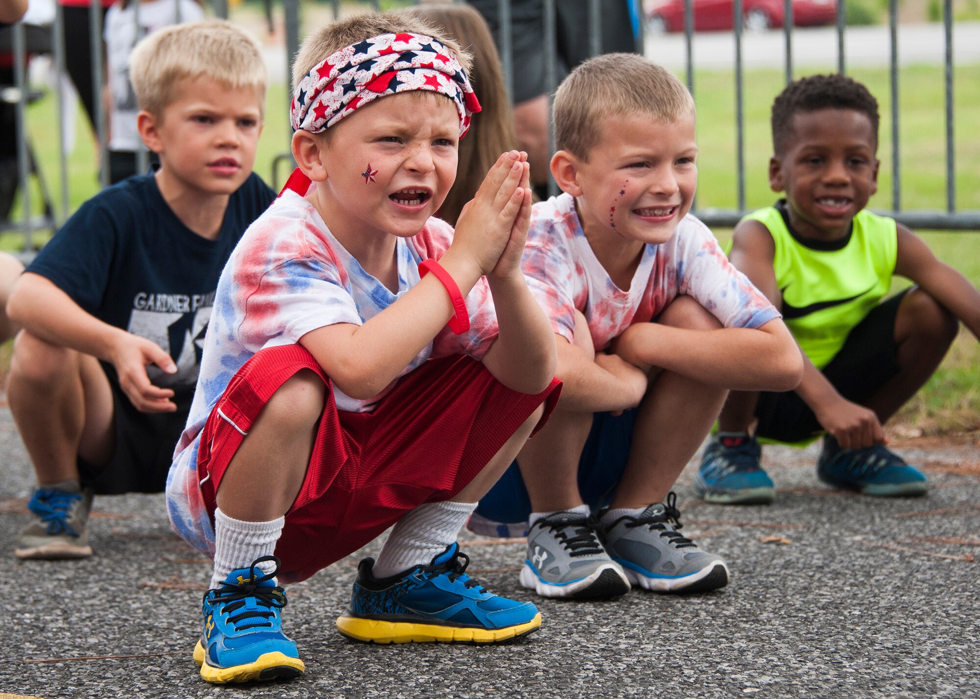 Little boys perform sumo squats to warm up before the kid’s fun run during the 31st annual Gate to Gate Run May 28 at Eglin Air Force Base, Fla. More than 1,050 runners and walkers partook in the Memorial Day Race and paid respects to the country’s fallen with red flowers at the All Wars Memorial as they ran by. (U.S. Air Force photo/Ilka Cole)
