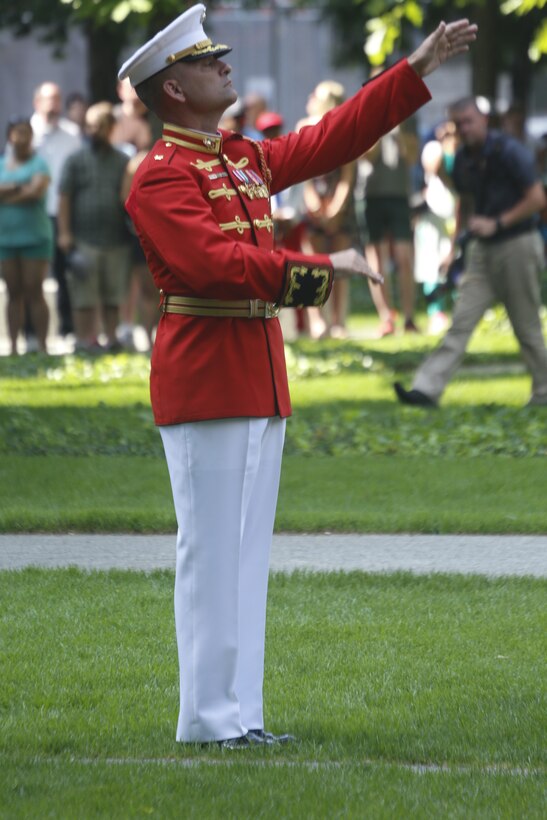 U.S. Marine Maj. Christopher E. Hall, commanding officer and director of The Commandant’s Own, conducts the Drum and Bugle Corps at the 9/11 Memorial during Fleet Week New York, May 29, 2016. U.S. Marines and sailors are in New York to interact with the public, demonstrate capabilities, and teach the people of New York about America’s sea service. (U.S. Marine Corps Photo by Lance Cpl. Jimmy J. Vertus Combat Camera/Released).