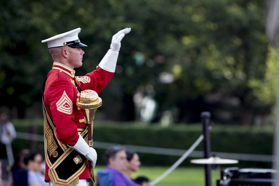 Master Gunnery Sgt. Keith Martinez, drum major, United States Marine Drum and Bugle Corps, performs during the Sunset Parade at the Marine Corps War Memorial, Arlington, Va., May 31, 2016. The guest of honor for the parade was Rear Adm. Valter Zappellini, Dean of Corps of Foreign Naval Attachés, Italian Navy, and the hosting official was Brigadier Gen. Michael S. Groen, director of Intelligence, J-2. (Official Marine Corps photo by Cpl. Chi Nguyen/Released)
