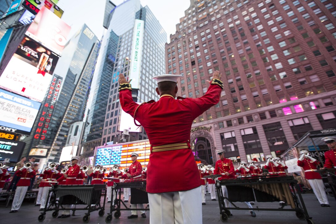 U.S. Marine Maj. Christopher Hall, the commanding officer and director of The Commandant’s Own, directs the Drum and Bugle Corps during a performance at Times Square in New York during Fleet Week, May 28, 2016. Marines, sailors and Coast Guardsmen are in New York to interact with the public, demonstrate capabilities and teach the people of New York about America’s sea services. (U.S. Marine Corps photo by Cpl. Todd F. Michalek/Released)