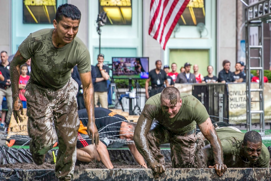 Marines compete in an obstacle course for a news program in New York City, May 28, 2016. Marines and sailors were in New York for Fleet Week to interact with the public, demonstrate capabilities and inform residents about America's sea services. Marine Corps photo by Cpl. Jonah Lovy