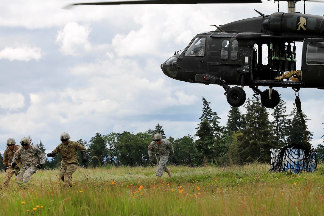 Soldiers rush away after hooking up cargo during slingload operations with a UH-60 Black Hawk helicopter at Joint Base Lewis-McChord, Wash., May 20, 2016. Army photo by Capt. Tania Donovan