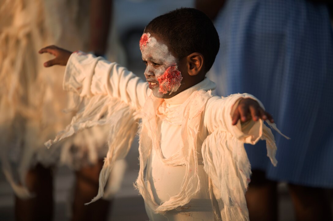 Markel Powell participates in the 6th Annual Okinawa Zombie Walk at American Village, Okinawa, Japan, on October 30, 2016. The event was an opportunity for locals and service members to come out and display their zombie costumes. Service members and civilians also volunteered to guide the zombies as they had their pictures taken. Powell’s father, Chief Warrant Officer Three Fitzroy Powell, is a personnel officer with 12th Marine Regiment, 3rd Marine Division, III Marine Expeditionary Force. Powell and his son are from New York. (U.S. Marine Corps photo by Lance Cpl. Nelson Duenas/ Released)