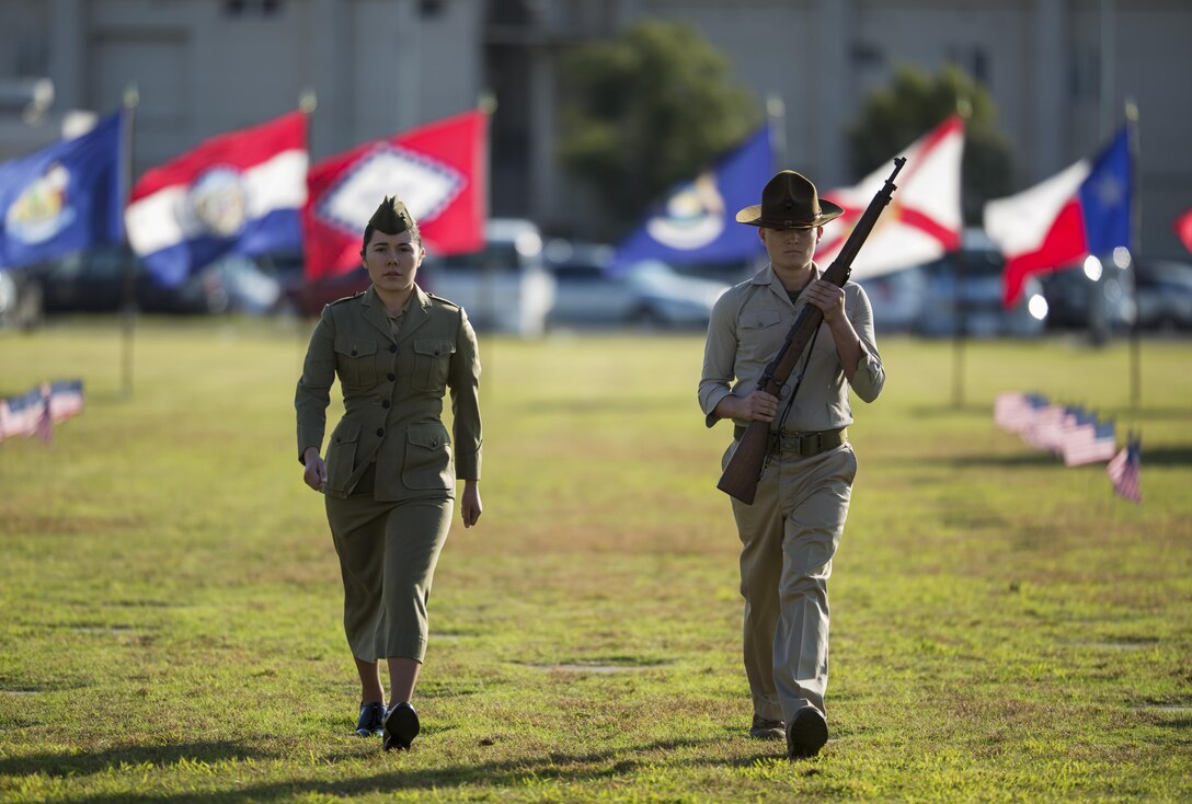 Lance Cpl. Jennifer Rosas, left, and Pfc. Normand Corthell, right, dressed in 1904-1935 era Marine Corps uniform, participates in the 241st Marine Corps birthday uniform pageant on the parade deck at Marine Corps Air Station Iwakuni, Japan, Nov. 1, 2016. The ceremony displayed uniforms dating back to 1775, honoring traditional Marine Corps uniforms and history. (U.S. Marine Corps photos by Sgt. Carlos Cruz Jr.)