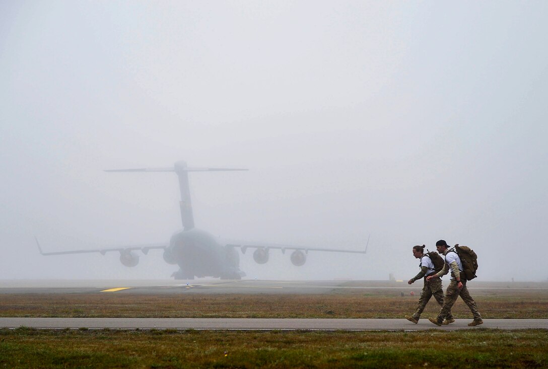Ruck and run participants march along the flightline at Ramstein Air Base, Germany, Oct. 28, 2016. The event was sponsored by the 786th Civil Engineer Squadron’s explosive ordnance disposal flight in support of the Combined Federal Campaign. (U.S. Air Force photo by Airman 1st Class Joshua Magbanua)