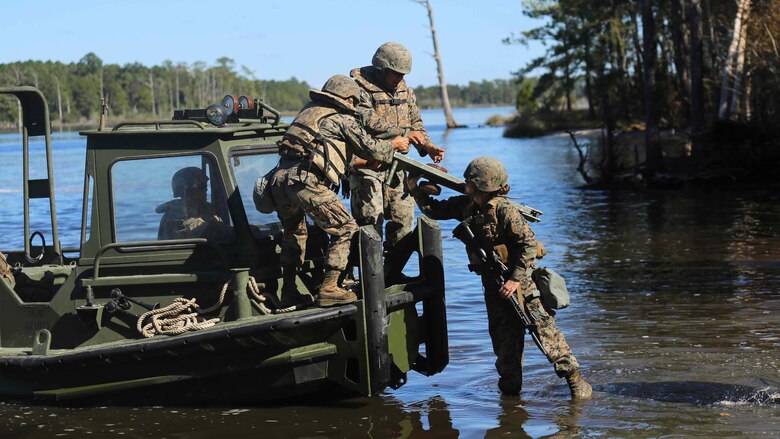 Marines with 1st Platoon, Bridge Company, 8th Electronic Support Battalion, transfer equipment to secure the improvised ribbon raft during the Marine Corps Combat Readiness Evaluation at Camp Lejeune, N.C., Oct. 26, 2016. The IRR  has two parts, an interior bay and a ramp bay which link together to make a bridge.