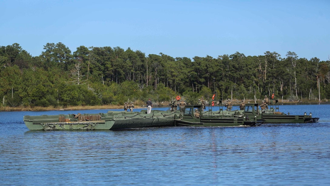 Marines with 1st Platoon, Bridge Company, 8th Electronic Support Battalion, link pieces of an improvised ribbon raft together to create a ramp for Marines from 3rd Battalion, 8th Marines to cross the waterway during the Marine Corps Combat Readiness Evaluation at Camp Lejeune, N.C., Oct. 26, 2016. The raft will be used to load, transport and deliver Marines and their vehicles during the following phase of the MCCRE. 