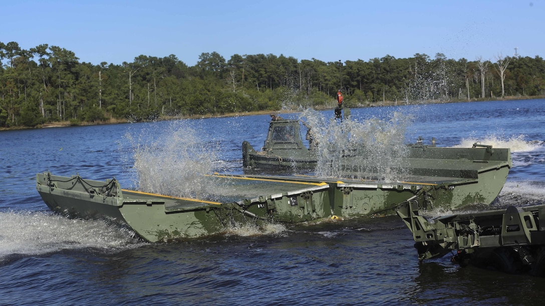 Marines with 1st Platoon, Bridge Company, 8th Electronic Support Battalion, deliver part of an improvised ribbon raft to be interlocked with other pieces during the Marine Corps Combat Readiness Evaluation at Camp Lejeune, N.C., Oct. 26, 2016. The IRR is used for rafting operations to transport materials and personnel across wet gaps, or waterways. 