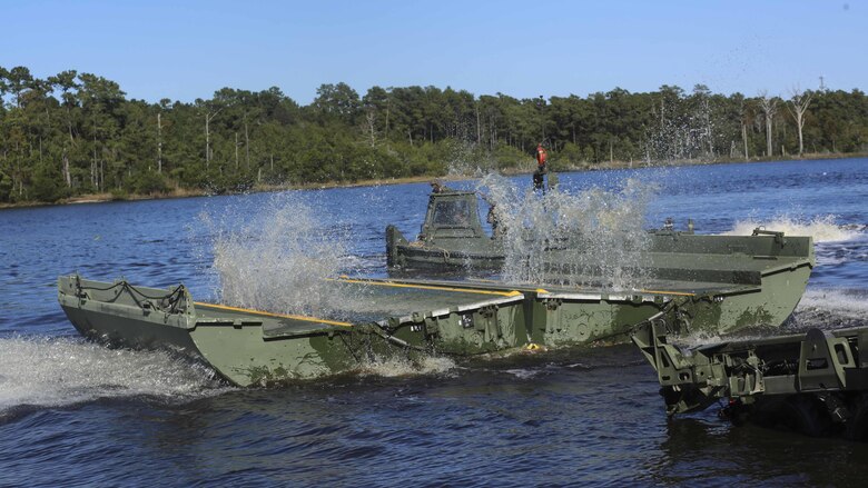 Marines with 1st Platoon, Bridge Company, 8th Electronic Support Battalion, deliver part of an improvised ribbon raft to be interlocked with other pieces during the Marine Corps Combat Readiness Evaluation at Camp Lejeune, N.C., Oct. 26, 2016. The IRR is used for rafting operations to transport materials and personnel across wet gaps, or waterways. 