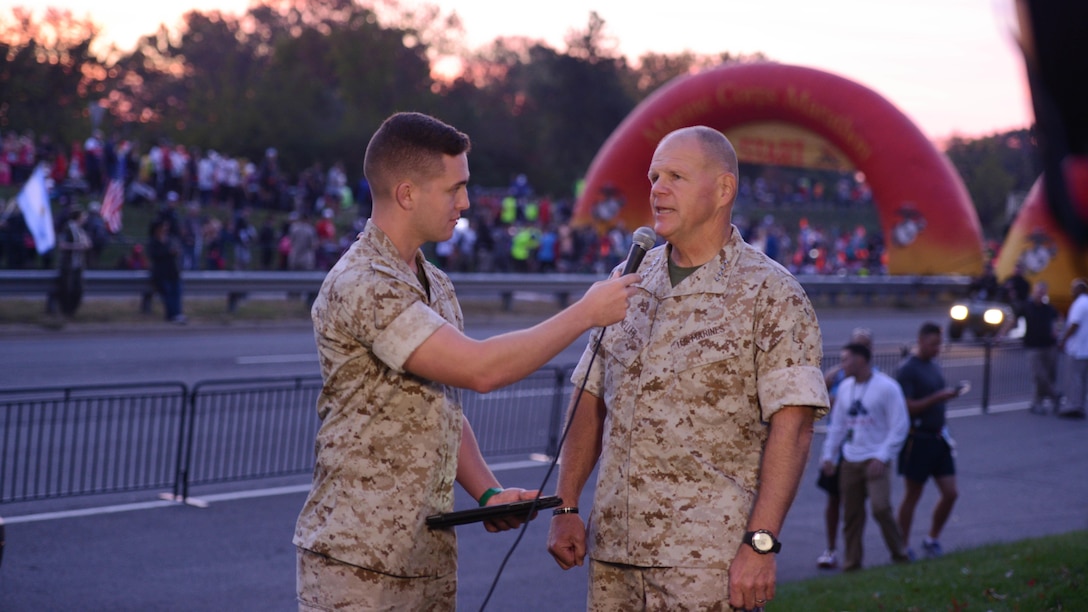 Gen. Robert B. Neller, Commandant of the Marine Corps, talks with Cpl. Warren Smith about the upcoming Marine Corps Marathon in Arlington, Virginia, Oct. 30, 2016. This is Neller's second Marathon as Commandant of the Marine Corps.
