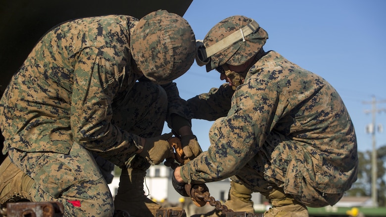 Marines secure an amphibious assault vehicle to a railcar during railhead operation training at Camp Lejeune, N.C., Oct. 26, 2016. 2nd Transportation Support Battalion participated in the training to get Marines certified to conduct railhead operations in the future. The Marines are with 2nd TSB. 