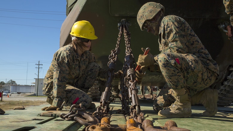 (From left to right) Lance Cpl. Alexis Smith and Pfc. Troy Lewis secure an amphibious assault vehicle to a railcar during railhead operation training at Camp Lejeune, N.C., Oct. 26, 2016. 2nd Transportation Support Battalion participated in the training to get Marines certified to conduct railhead operations in the future. Smith and Lewis are landing support specialists with 2nd TSB. 