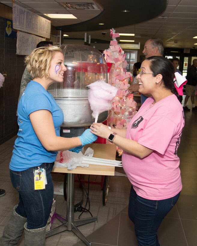 Staff Sgt. Stephanie Libid, 436th Medical Support Squadron NCO in charge of Outpatient Records, hands out cotton candy during the Health Fair hosted by the 436th Medical Group Oct. 28, 2016, on Dover Air Force Base, Del. Cotton candy, popcorn and face painting were offered free to all attendees. (U.S. Air Force photo by Mauricio Campino)
