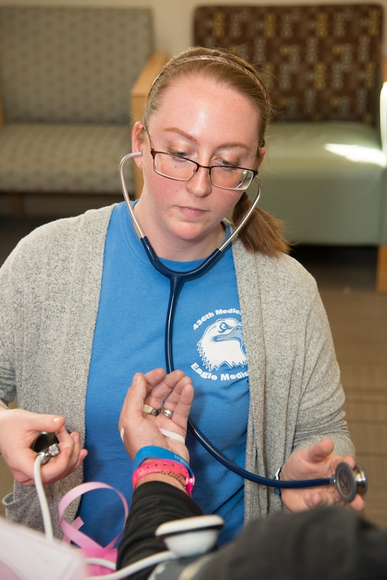 Airman 1st Class Leah Holland, 436th Medical Operations Squadron, measures a guest’s blood pressure during the Health Fair hosted by the 436th Medical Group Oct. 28, 2016, on Dover Air Force Base, Del. Attendees were offered free medical information on topics such as high blood pressure, tobacco cessation, diabetes and breast cancer. (U.S. Air Force photo by Mauricio Campino)