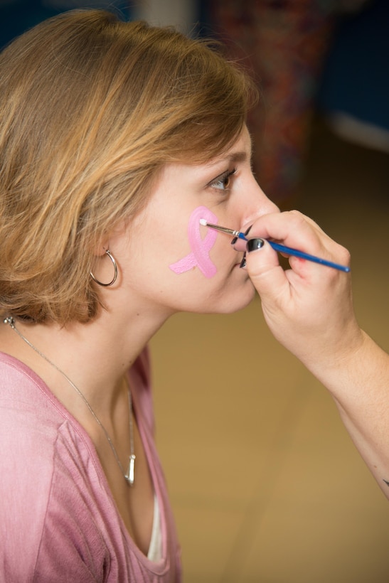 Airman 1st Class Karie Thomas, 436th Aerospace Medicine Squadron public health technician, gets her face painted during the Health Fair hosted by the 436th Medical Group Oct. 28, 2016, on Dover Air Force Base, Del.  Besides offering helpful health information the fair also offered free kids activities, face painting and door prizes. (U.S. Air Force photo by Mauricio Campino)