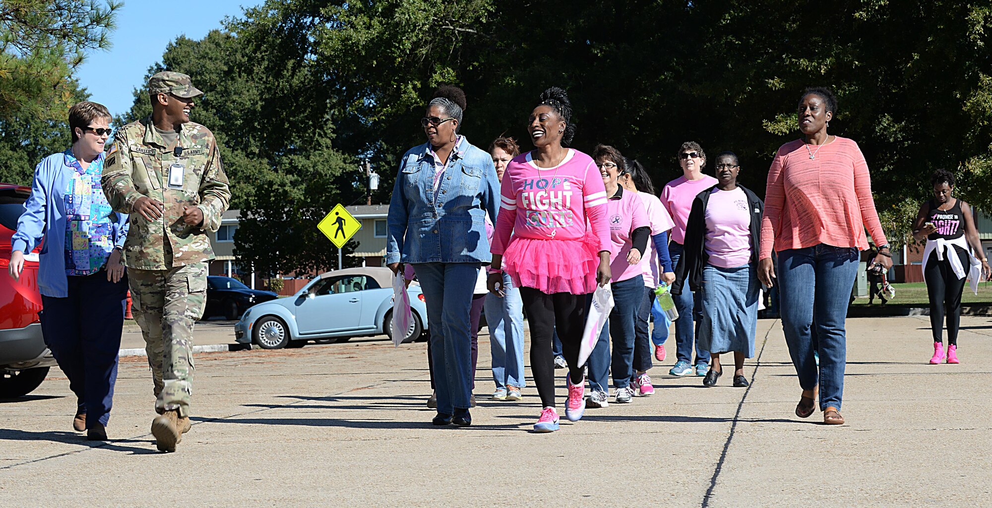 Members of the Joint Base Langley-Eustis community encourage each other during the Breast Cancer Awareness Month walk at JBLE, Va., Oct. 28, 2016. According to the National Cancer Institute, approximately five of every 1,000 women who have regular mammogram screenings will be diagnosed with breast cancer. (U.S. Air Force photo by Staff Sgt. Teresa J. Cleveland)