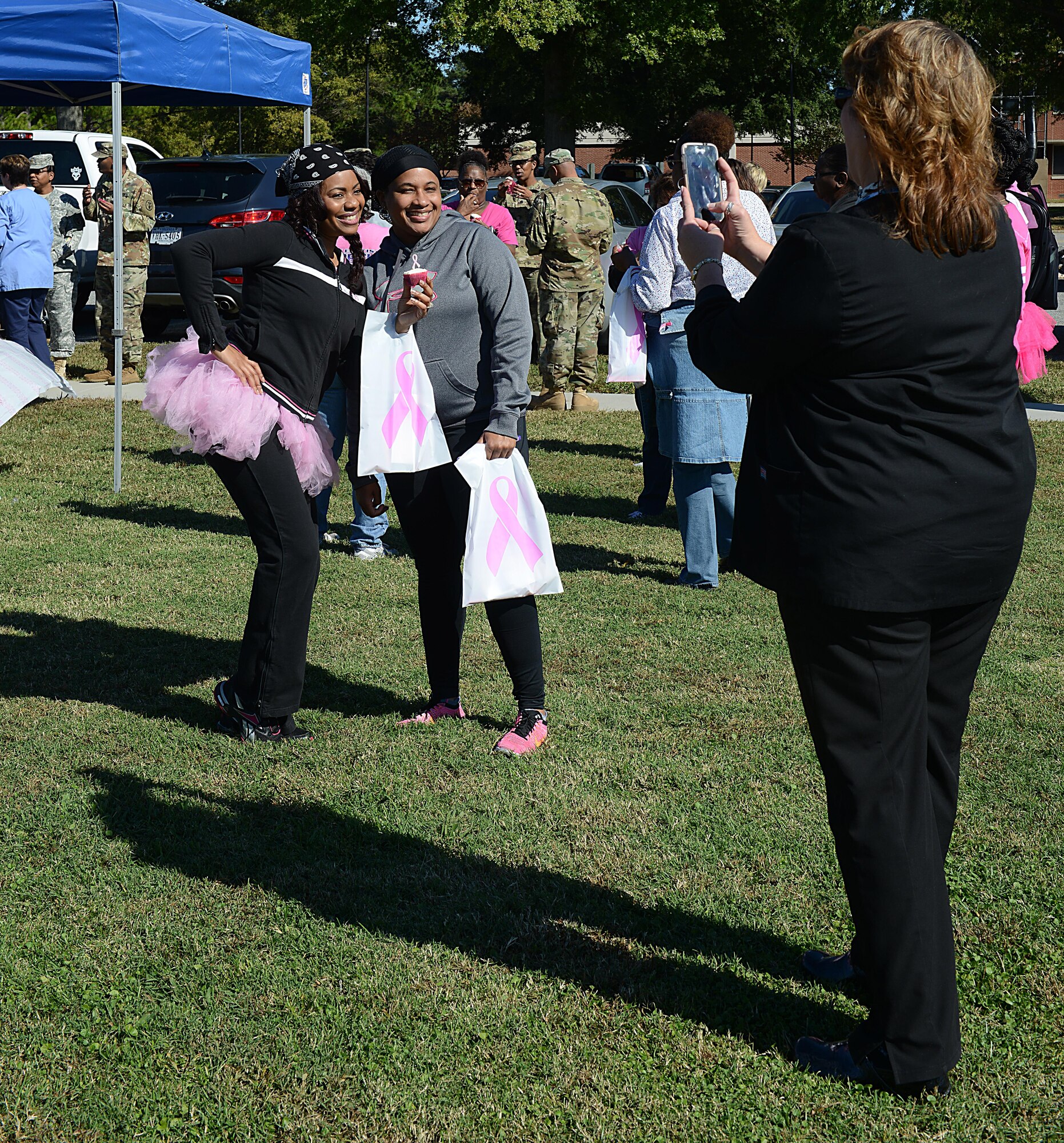 Members of the Joint Base Langley-Eustis, community take photographs in pink gear after completing the Breast Cancer Awareness Month walk at JBLE, Va., Oct. 28, 2016. According to members of the McDonald Army Health Center women’s health clinic and Langley Hospital mammography section, women should perform monthly self-breast exams and report abnormalities to their primary care physician. (U.S. Air Force photo by Staff Sgt. Teresa J. Cleveland)
