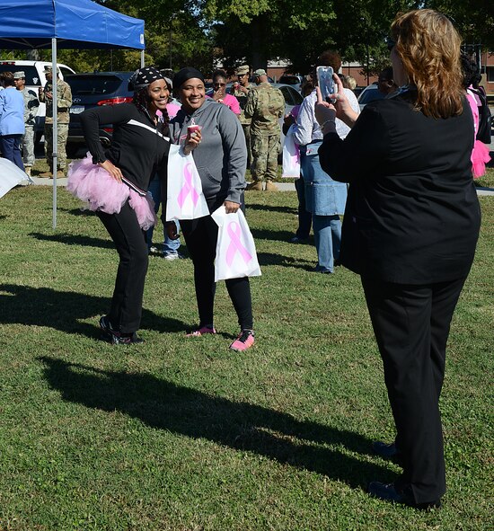 Members of the Joint Base Langley-Eustis, community take photographs in pink gear after completing the Breast Cancer Awareness Month walk at JBLE, Va., Oct. 28, 2016. According to members of the McDonald Army Health Center women’s health clinic and Langley Hospital mammography section, women should perform monthly self-breast exams and report abnormalities to their primary care physician. (U.S. Air Force photo by Staff Sgt. Teresa J. Cleveland)