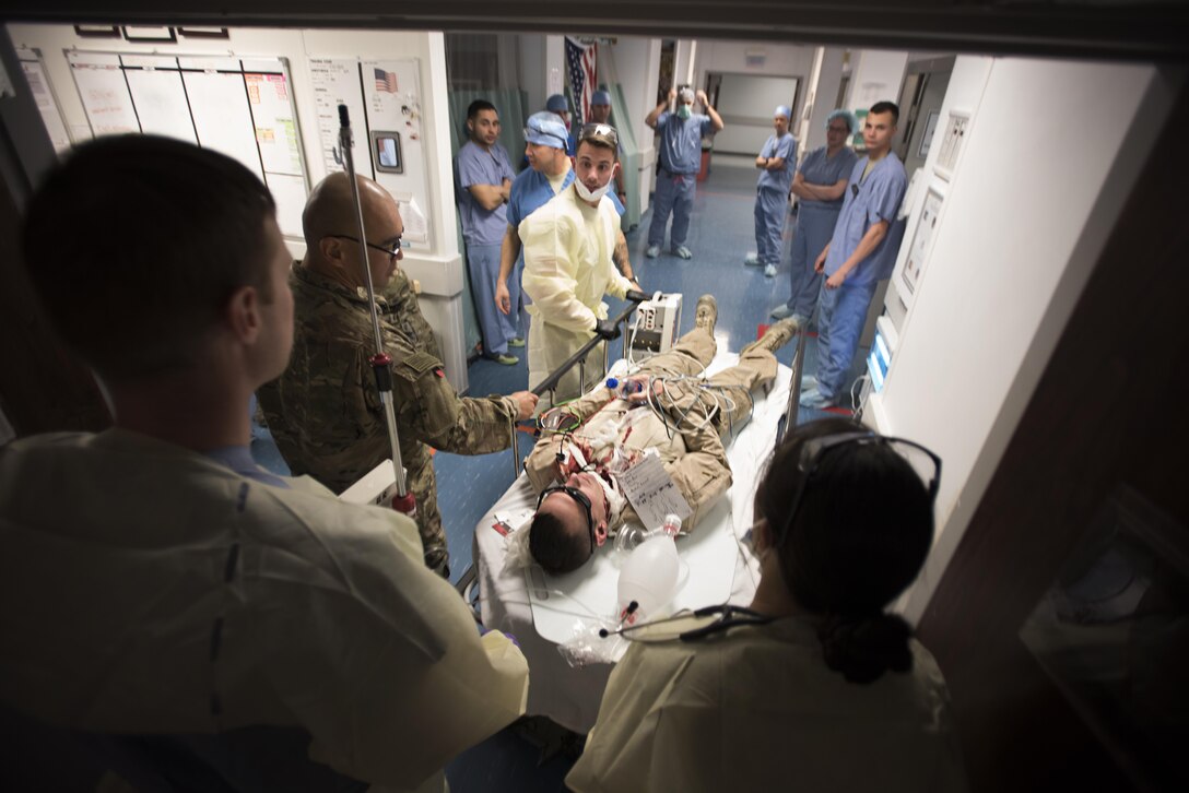 U.S. Army Sgt. Seth Pilkington, 233rd Military Police Company, is taken to the operating room during a mass casualty exercise Oct. 30, 2016 at the Craig Joint Theater Hospital, Bagram Airfield, Afghanistan. Thirteen patients were medically evacuated by helicopter from the embassy in Kabul for the exercise. (U.S. Air Force photo by Staff Sgt. Katherine Spessa)
