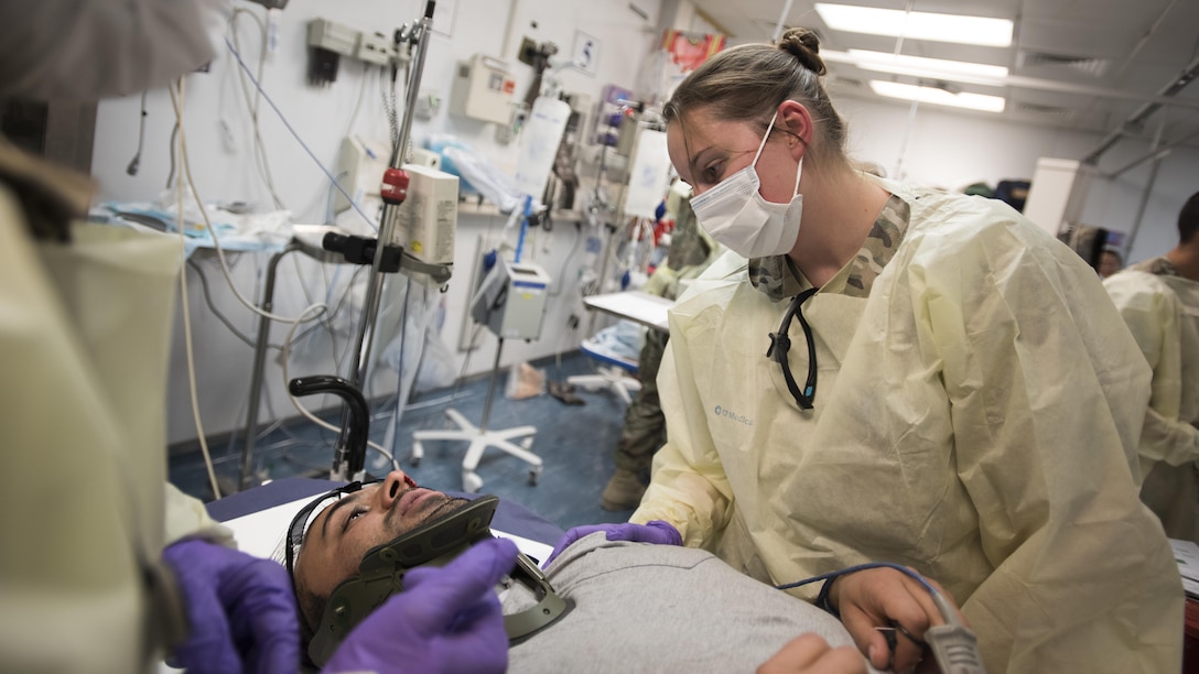 Tech. Sgt. Mandy Mueller, 455th Expeditionary Medical Group paramedic, comforts a patient during a mass casualty exercise Oct. 30, 2016 at the Craig Joint Theater Hospital, Bagram Airfield, Afghanistan. The purpose of the drill was to create a realistic scenario of an incident that may happen on their tour and run through how each team would handle their roles. (U.S. Air Force photo by Staff Sgt. Katherine Spessa)
