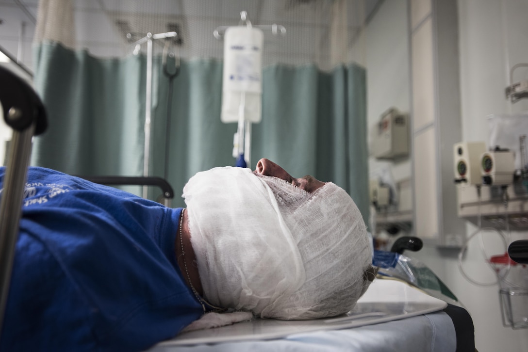 Dato Sherazio, a NATO civilian at the embassy in Kabul, lies in the intensive care ward after being treated during a mass casualty exercise at the Craig Joint Theater Hospital, Bagram Airfield, Afghanistan, Oct. 30, 2016. Volunteer patients applied moulage, makeup made to look like realistic injuries, at the embassy in Kabul and were then evacuated via helicopter to CJTH at Bagram. (U.S. Air Force photo by Staff Sgt. Katherine Spessa)

