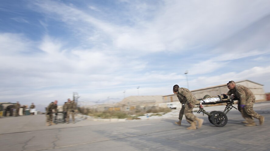 A medical response team carries a patient by litter while another team waits to accept the next patient during a mass casualty exercise at the Craig Joint Theater Hospital, Bagram Airfield, Afghanistan, Oct. 30, 2016. More than a dozen patients were treated at the hospital after a simulated improvised explosive device attack. (U.S. Air Force photo by Staff Sgt. Katherine Spessa)
