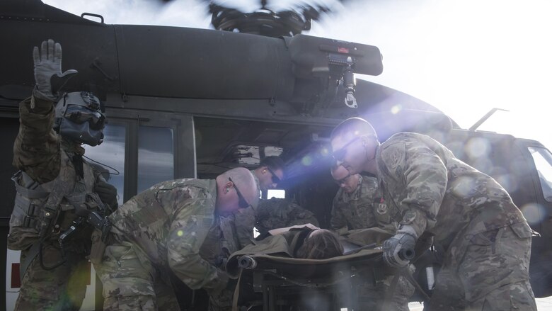 A medical response team moves a patient to a litter during a mass casualty exercise Oct. 30, 2016 at Bagram Airfield, Afghanistan. The exercise was used to streamline medical response beginning with a patient’s medical evacuation through their treatment at the Craig Joint Theater Hospital. (U.S. Air Force photo by Staff Sgt. Katherine Spessa)
