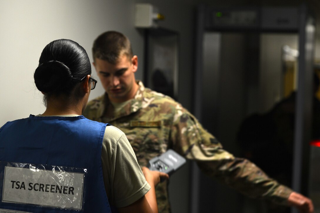 A U.S. Airman assigned to the 20th Logistics Readiness Squadron screens a deploying Airman at the Chandler Deployment Processing Center at Shaw Air Force Base, S.C., Oct. 21, 2016. Airmen were screened to ensure they met all Transportation Security Administration regulations before boarding an aircraft for deployment. (U.S. Air Force photo by Airman 1st Class Christopher Maldonado)