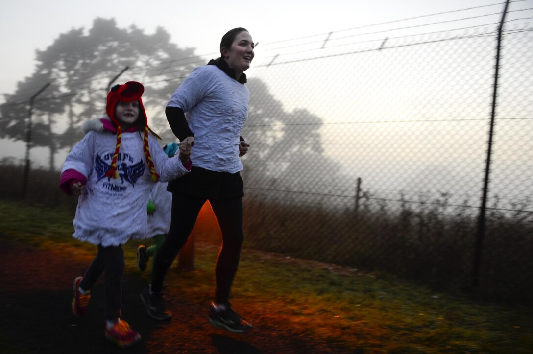 Airmen and their families flee the walking dead during the Zombie Run at Royal Air Force Lakenheath, England, Oct. 31. Those who weren’t fast enough to escape, were covered in zombie blood. (U.S. Air Force photo/Senior Airman Malcolm Mayfield)