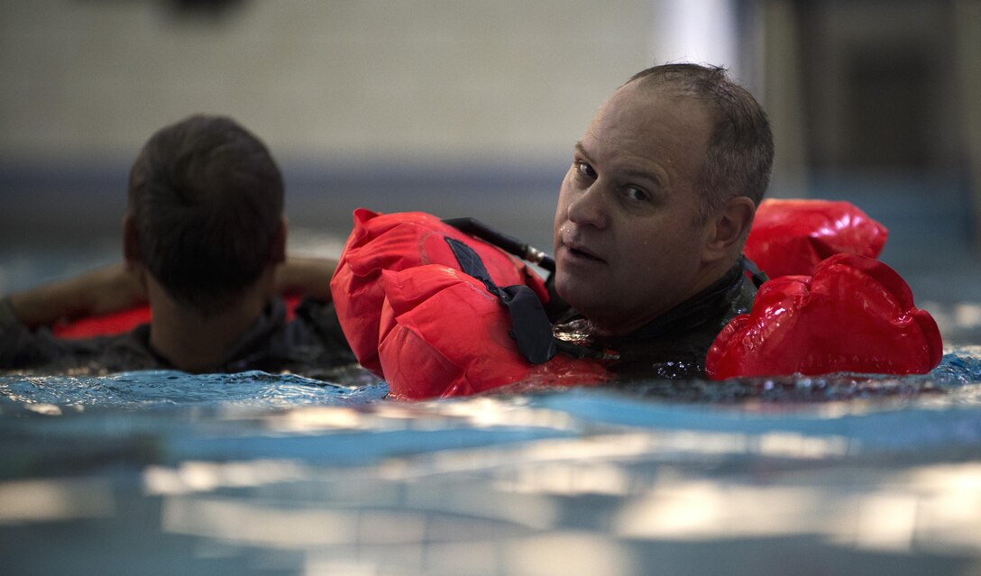 Lt. Col. Richard Sutton, Defense Threat Reduction Agency mission commander, side-swims while pulling a classmate during Water Survival Training at Prince George’s Community College’s Robert I. Bickford Natatorium in Largo, Md., Oct. 27, 2016. The side-swim technique is used when pulling another individual who might be hurt or unconscious to make swimming easier. (U.S. Air Force photo by Senior Airman Philip Bryant)
